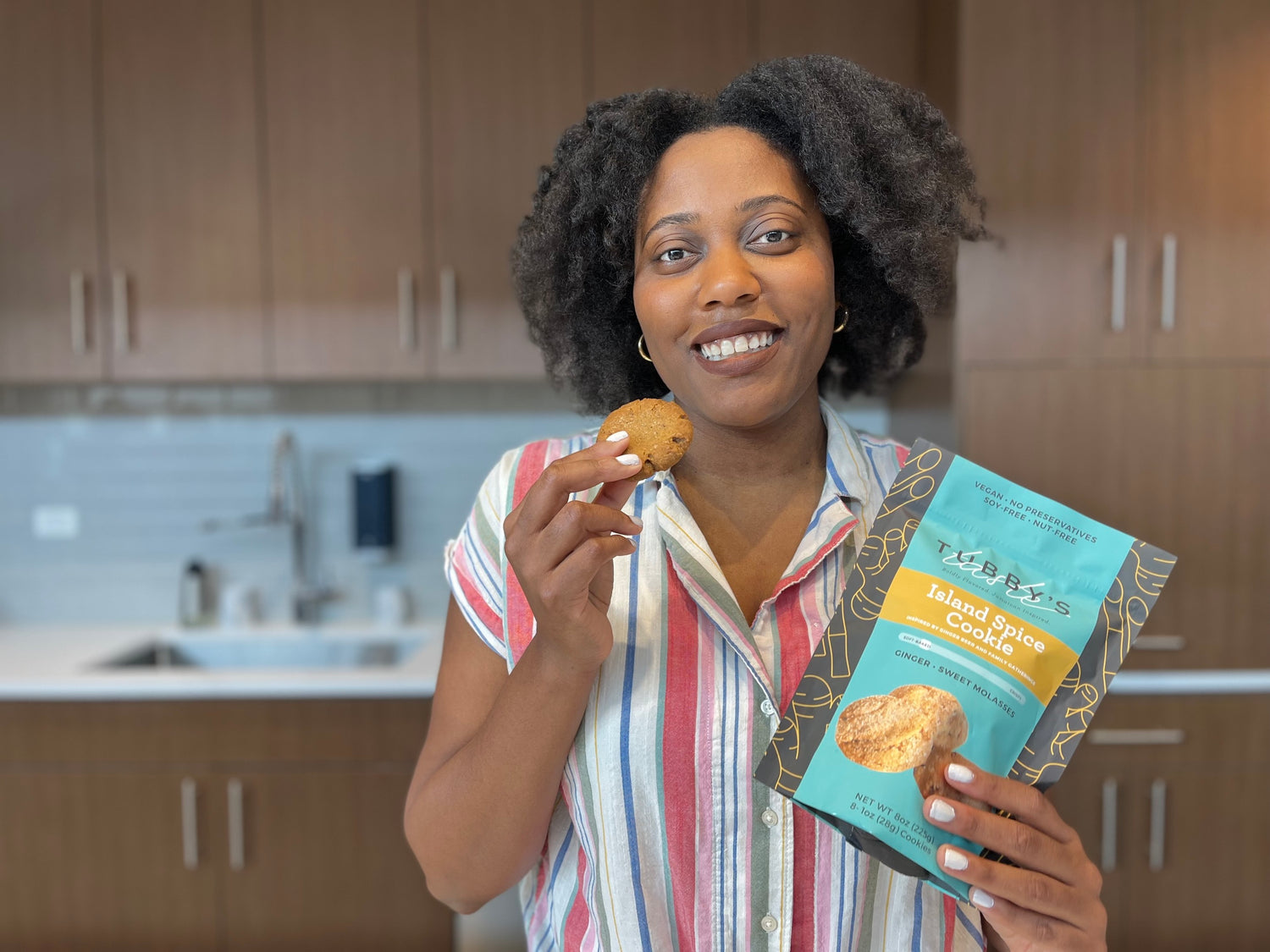 A picture of Tubby holding a bag of ginger molasses cookies and smiling.